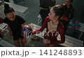 Graceful Rhythmic Gymnast Warming Up with Purple Ball in Dressing Room. 141248893