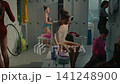 Teenage Rhythmic Gymnasts Busy with Pre Competition Routines inside Locker Room 141248900