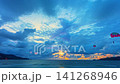 Time lapse Cinematic evening landscape of Patong Beach with colorful pink skies, dramatic cloud formations, and golden reflections across the Andaman Sea. 141268946