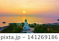 Aerial Hyper lapse of Phuket Big Buddha illuminated by warm evening light above Phuket Island, offering spectacular views of the surrounding sea. Spectacular Landscape of Phuket Famous Landmark 141269186