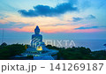 Aerial Hyper lapse of Phuket Big Buddha illuminated by warm evening light above Phuket Island, offering spectacular views of the surrounding sea. Spectacular Landscape of Phuket Famous Landmark 141269187