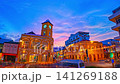 Time lapse Beautiful blue hour cityscape featuring the historic clock tower in Phuket Old Town with illuminated heritage buildings, dynamic traffic, and stormy clouds. 141269188