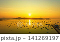 Panoramic sunrise over Chalong Bay featuring luxury yachts, fishing boats, and the iconic marina surrounded by the peaceful waters of southern Thailand. Peaceful Sunrise at Chalong Pier Phuket Island 141269197