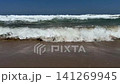 Ocean Waves Breaking on Sandy Beach 141269945