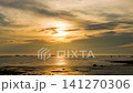 Sky transform from sunset to a radiant twilight, with beautiful clouds painting the twilight horizon at a beach in the ocean. 141270306