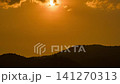 Timelapse of dramatic sunset with orange sky in a cloudy day. 141270313