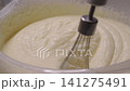 Mixer whipping milk cream for cake in plastic bowl 141275491