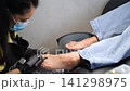 A woman's feet during a pedicure. Woman getting pedicure in beauty salon, closeup. A pedicurist working at a beauty salon. Beauty salon concept: pedicures. A woman's feet during a pedicure. Woman getting pedicure in beauty salon, closeup. A pedicurist working at a beauty salon. Beauty salon concept: pedicures. 141298975