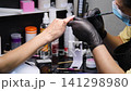 A woman's hand during a manicure. A woman getting a manicure. A manicurist is doing a client's nails at a nail salon. Beauty salon concept: manicures, pedicures. A woman's hand during a manicure. A woman getting a manicure. A manicurist is doing a client's nails at a nail salon. Beauty salon concept: manicures, pedicures. 141298980