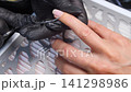 A woman's hand during a manicure. A woman getting a manicure. A manicurist is doing a client's nails at a nail salon. Beauty salon concept: manicures, pedicures. A woman's hand during a manicure. A woman getting a manicure. A manicurist is doing a client's nails at a nail salon. Beauty salon concept: manicures, pedicures. 141298986
