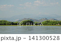 Panoramic view of Skadar Lake in Montenegro with calm waters, green wetlands and mountain ranges stretching across the horizon. A peaceful summer landscape of one of the Balkans  141300528