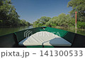 Boat ride through the waterways of Skadar Lake National Park in Montenegro. Scenic summer view from a traditional boat surrounded by lush vegetation and calm freshwater landscape 141300533