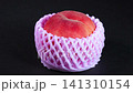 A close-up of a single fresh white peach rotating against a black background. 141310154