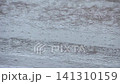 A scene of rain pouring down on the asphalt ground. 141310159
