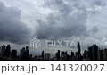 Fast-moving storm clouds gather over the Bangkok skyline, signaling an approaching downpour. 141320027