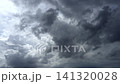 Fast-moving clouds converge in the sky, signaling the arrival of heavy rainfall. 141320028