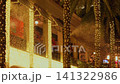 Artificial snow drifts through illuminated palm trees at a shopping promenade 141322986