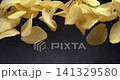 Ridged potato chips falling in super slow motion on black background 141329580