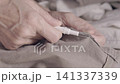 Seamstress using sewing un stitcher 141337339