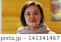 Woman shows different facial expressions in a simple setting 141341467