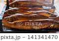 Grilling fresh fish for a delicious outdoor meal 141341470