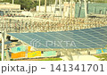 Elevated view of a solar panel canopy beside an urban substation 141341701