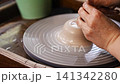 Learn to shape clay on a pottery wheel in a local studio 141342280