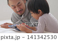 Kids playing with tablets Kids playing with tablets 141342530