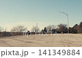Wind turbines spinning behind an empty parking lot 141349884