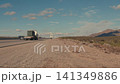 Military convoy trucks driving on highway in the desert 141349886