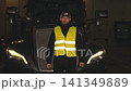 American truck driver wearing reflective vest at night 141349889