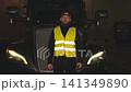 American truck driver wearing a reflective vest posing confidently 141349890