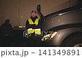 American truck driver standing next to his semi-truck at night 141349891