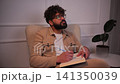 Thoughtful creative man writing ideas in journal 141350039