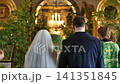 Orthodox wedding ceremony with bride and groom standing before the priest in church 141351845