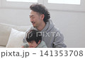 A dad holding a little boy in his arms. A dad holding a little boy in his arms. 141353708