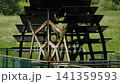 Waterwheel turning in green rural landscape, traditional technology and renewable energy 141359593