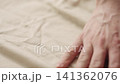 Slow motion man hand checking natural linen shirt cloth 141362076