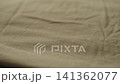 Slow motion man hand checking green cotton jersey cloth 141362077