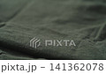 Slow motion man hand checking green linen jersey cloth 141362078