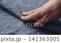 Slow motion man hand checking blue linen shirt cloth 141363005