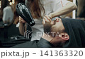 Barber Drying Client Beard In Barbershop 141363320