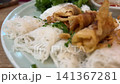 rice Vermicelli dish onions Bihun kuah or rice vermicelli noodle soup with vegetables, meat, shrimp and a sprinkle of fried onions in a bowl 141367281