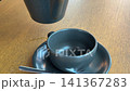 pour tea from a blue teapot Teapot cup saucer Studio shot of making traditional british cup of tea using teapot 141367283