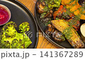 Rib eye steak with potatoes and broccoli and a glass of red wine, dining out, dinner, beef, medium rare. Tender beef tenderloin steak marinated in soy sauce and spices 141367289