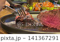 Steak grilled vegetables cut meat steak, beef pork neck cooking, Cook Butcher. The chef cuts the meat for cooking. Neck carbonate with vegetables cutting on ktchen for bbq grill, marinade.  141367291