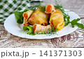 Korean pickled cabbage rolls stuffed with fresh carrot filling 141371303