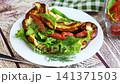 Fluffy omelet with red fish and fresh vegetable salad 141371503