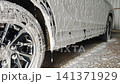 Car at car wash with foam suds dripping down vehicle 141371929