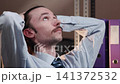 Thoughtful office worker leaning back in chair 141372532